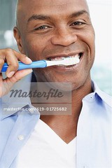 619-01725682em-African-American-man-brushing-teeth.jpg