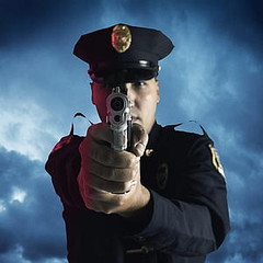 cop-with-gun-holding-wrist.jpg