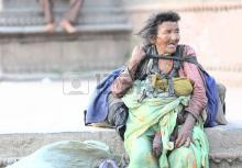 18536824-kathmandu-nepal--october-4-2012-old-homeless-woman-sits-beside-the-way-looking-at-the-people-passing.jpg
