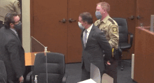 Chauvin in hand cuffs let out to pr.gif